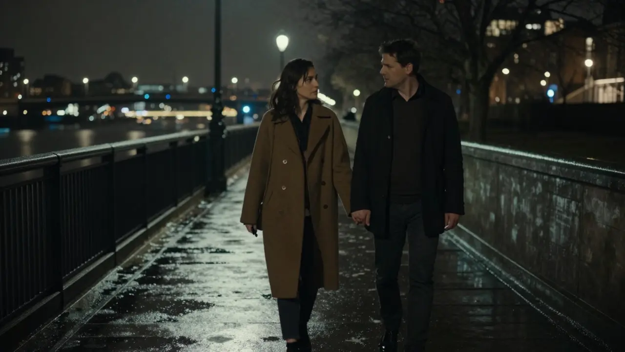 A man and woman walking silently along the Thames at night, rain glistening on the pavement, radiating quiet intimacy.