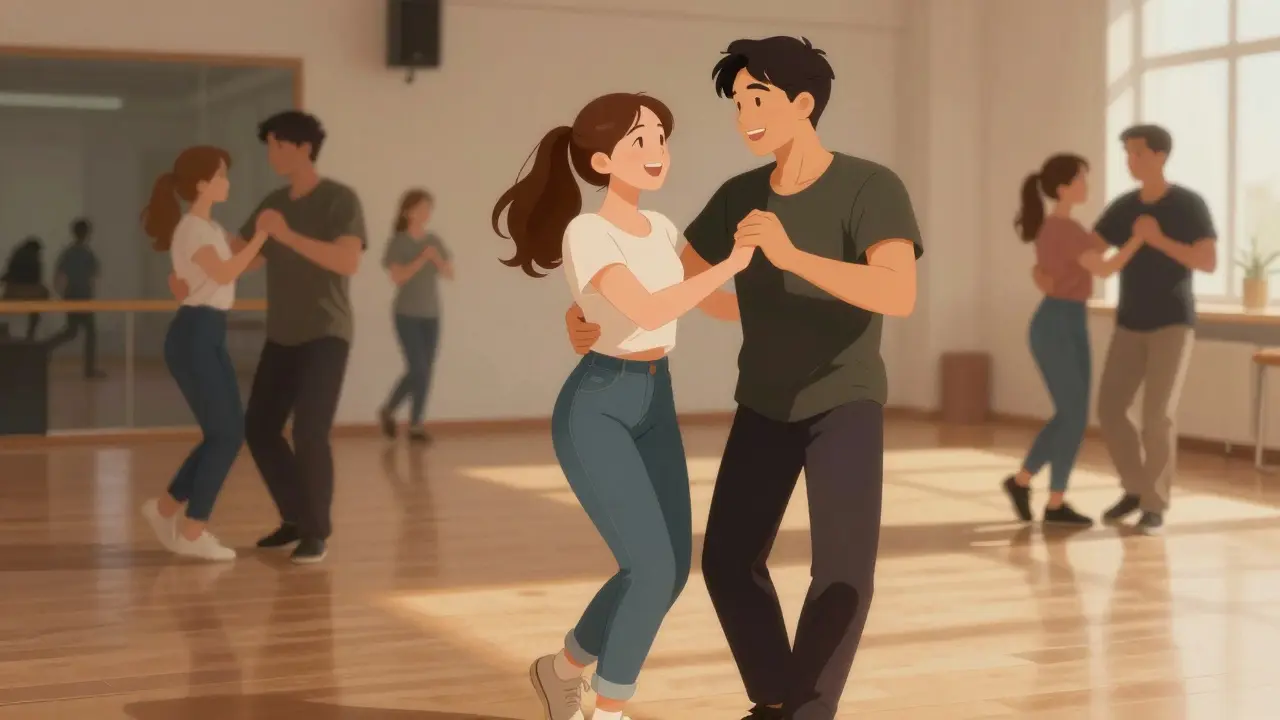 Two people laughing while learning salsa steps in a community dance class.