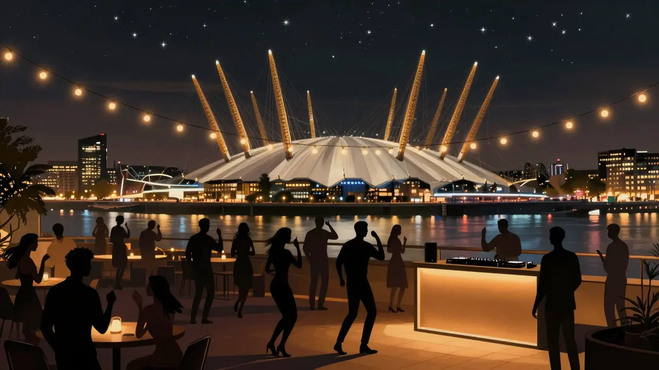 People dancing on a rooftop bar with London skyline and Thames glowing in the background.