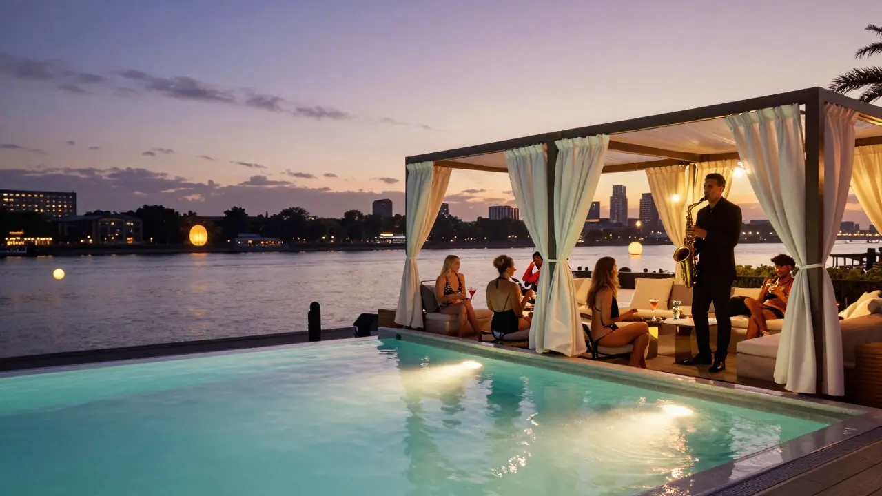 A glass-bottomed pool over the river with VIP cabanas and a saxophonist playing at sunset.